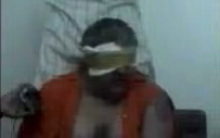 In the video, a blindfolded man speaking English identifies himself as a U.S. defense-industry employee who was abducted in the Saudi capital, Riyadh, on 12 June 2004.